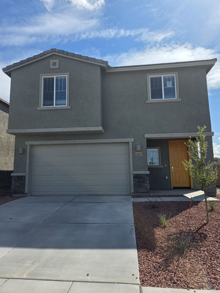 Exterior new-construction paint with warm yellow door accent